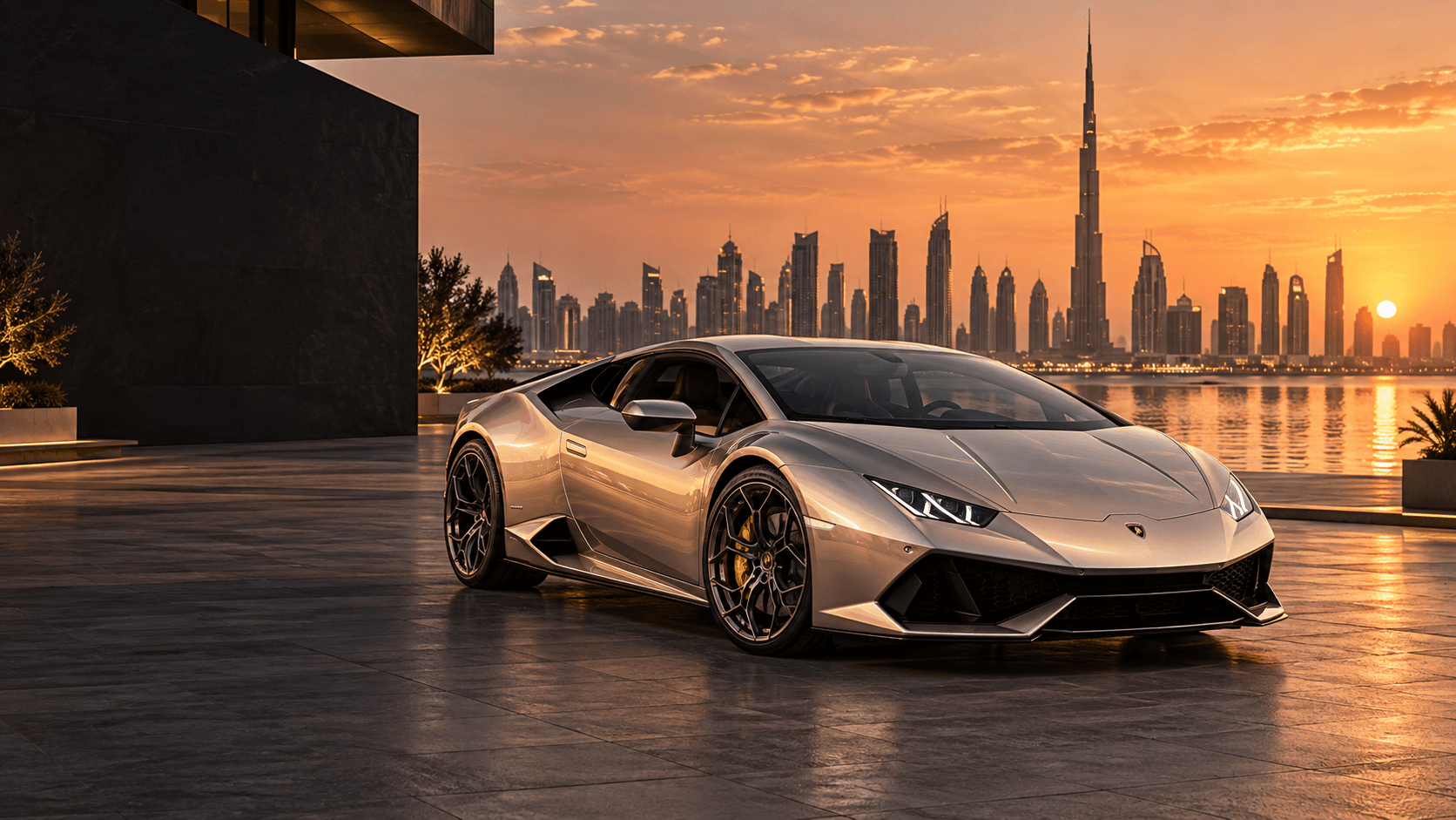 Silver supercar beside the Dubai waterfront at sunset